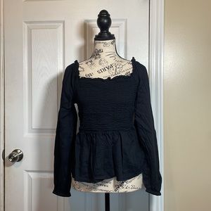 Flattering black top. Can be work on or off shoulder.
